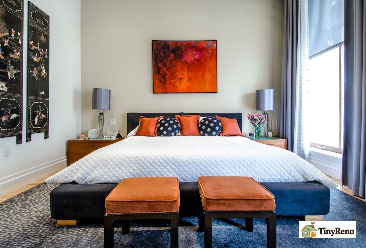 A bedroom with soft lighting and a white noise machine on a nightstand